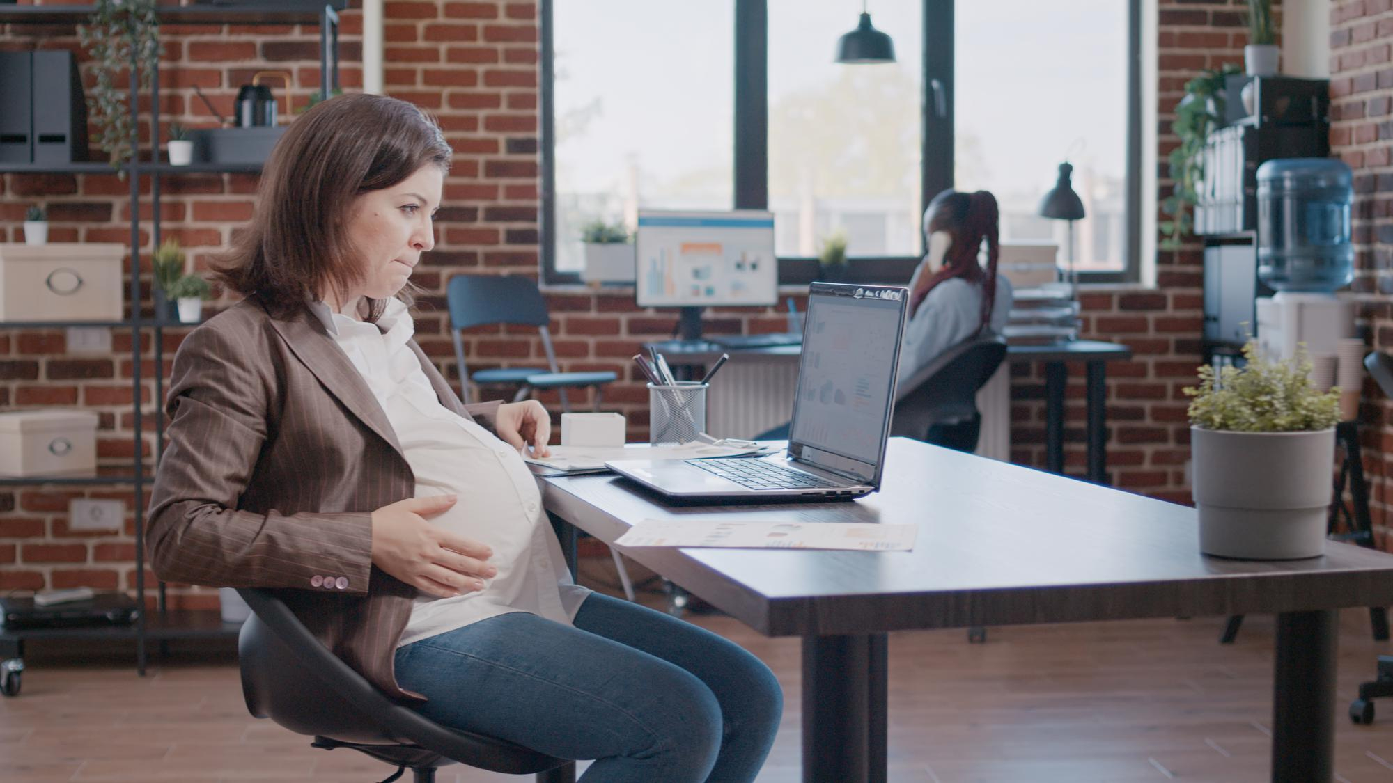 pregnant-business-woman-working-laptop-using-documents-marketing-strategy-startup-office-employee-expecting-child-working-project-planning-with-computer-files